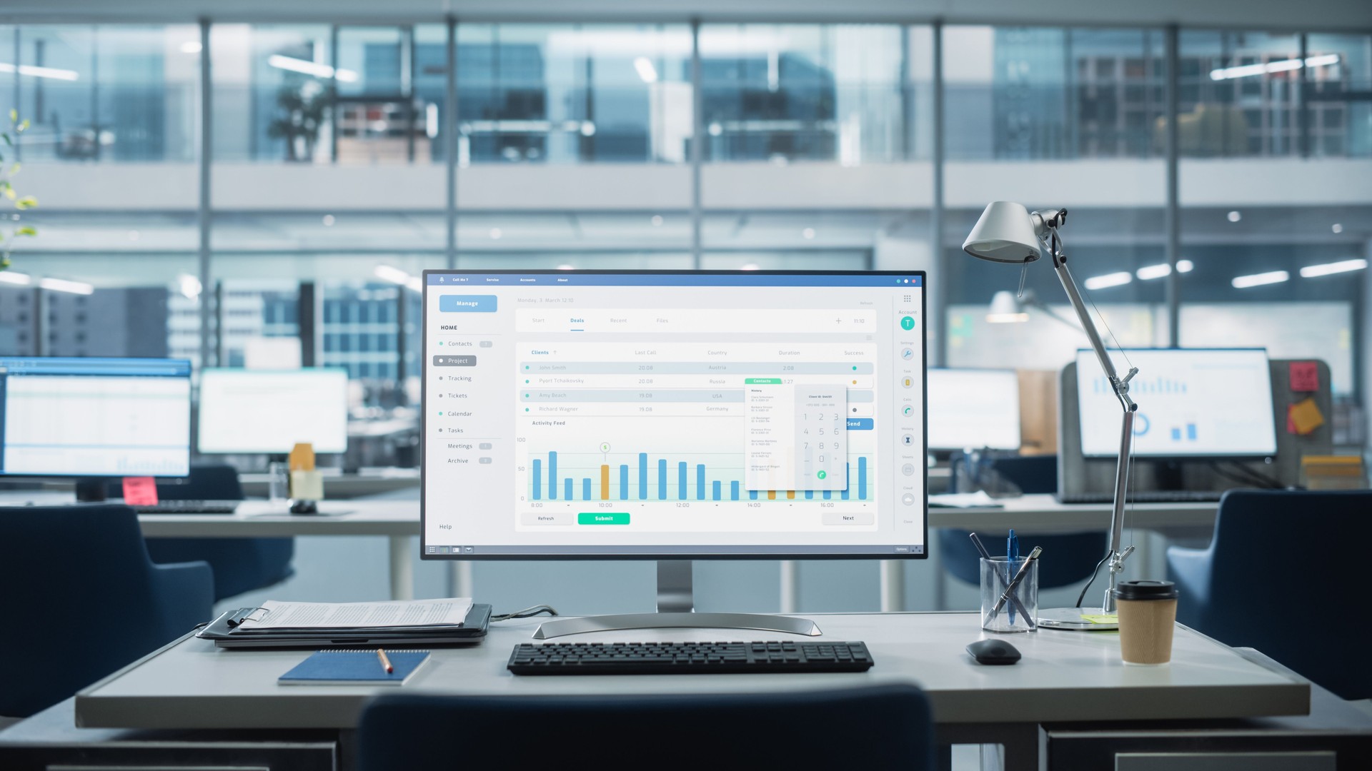 Desktop Computer Monitor with Finance Statistical Data Software and Progressive User Interface Standing on the Desk in the Modern Business Office. In the Background Glass Wall with Big City Office.